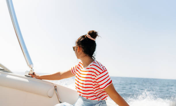 istock Young woman enjoys ride on a motorboat 1471179862