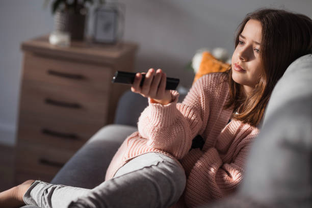 istock Girl resting in sofa and holding a remote control 1471179927