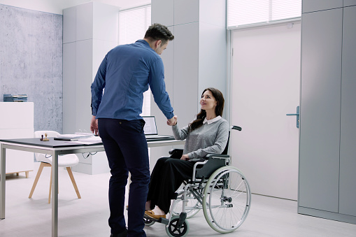 Person In Wheel Chair Handshake. Professional Consulting Job