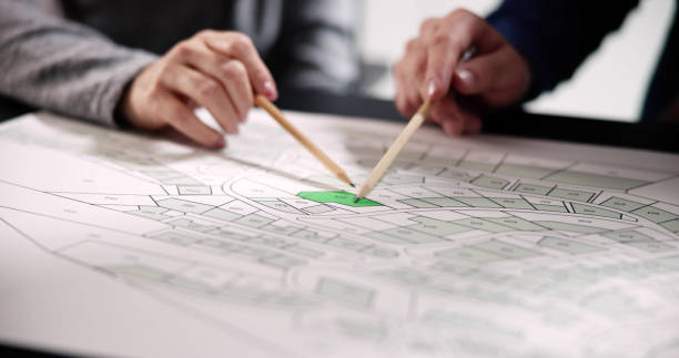 istock Human Hand Holding Pencil Over Paper Cadastre 1471187949