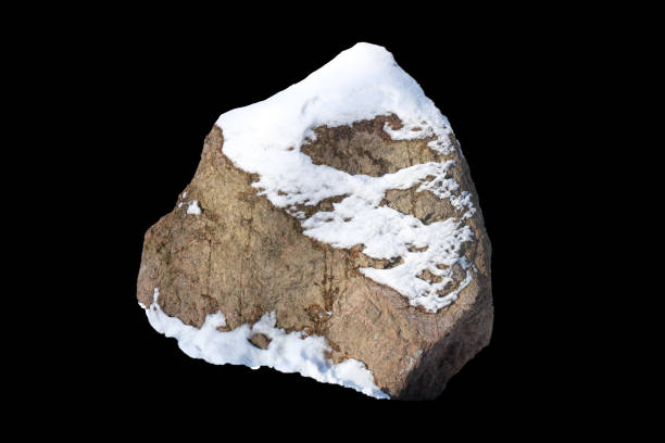 natural stone with snow isolated on black background