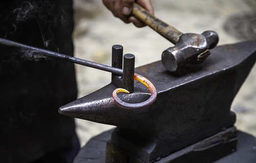 Interior, manufacturing and industrial with blacksmith workshop room for construction, engineering and metal work. Welding, maintenance and steel in factory warehouse  with anvil, forge and tools