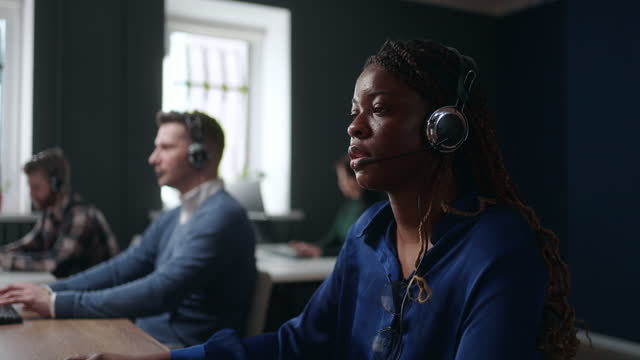 african woman working in call-center or telemarketing department, consulting and helping line