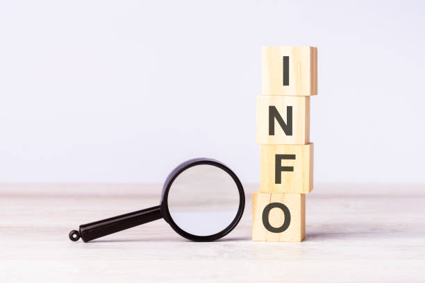 istock magnifying glass and wooden blocks with text INFO on wood table, grey background 1471190015