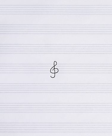 Treble clef in the middle on the sheet music. Notebook for music.