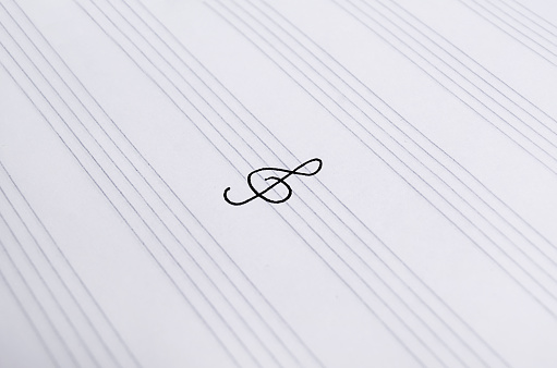 Treble clef close-up on music paper. Notebook for music.