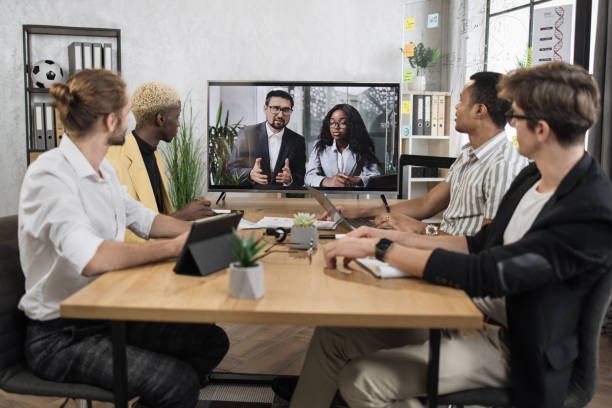istock Focused multiracial business people in conference room, looking at a screen 1471192980