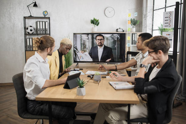 istock Confident young bearded caucasian man tells business program concept to his multinational colleagues 1471192981