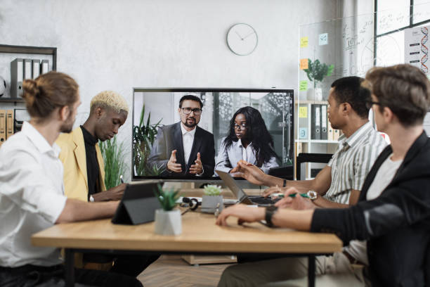 istock Focused multiracial business people in conference room, looking at a screen 1471192993
