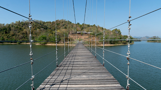 Phetchaburi, Thailand - March 03,2023 : The bridge over the water to the island in the reservoir. at Kaeng Krachan Reservoir Phetchaburi, Thailand.