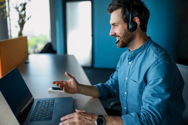 istock Bearded man sitting at the laptop and having a video call 1471195329