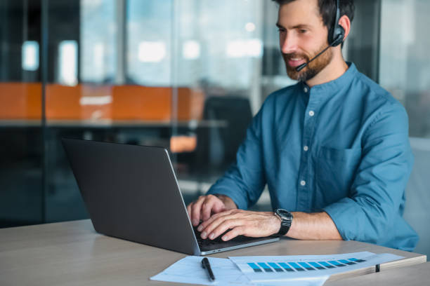 istock Young man in blue shirt having a business call 1471195332