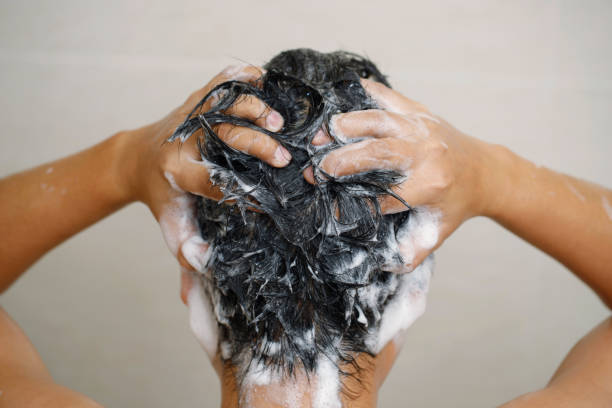 istock A man is washing his hair with shampoo 1471195680