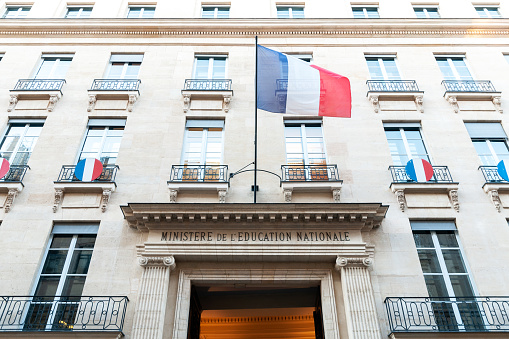 Paris : National Education ministry facade, with french flag. It's a State building of french administration, where the education minister work, with all his team, senior official and official or public servant. Situated rue de Grenelle in Paris, 7 th district – arrondissement – in France.