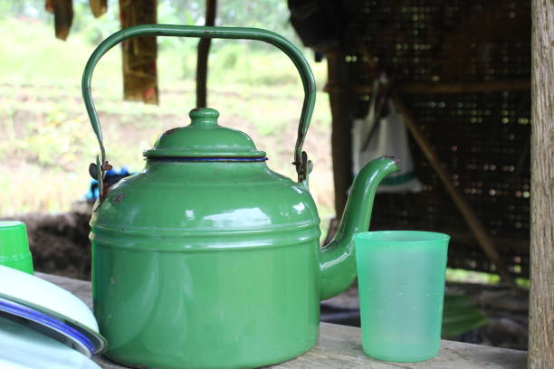 istock Ancient kettle placed on the old wooden.the old teapot is green 1471198459