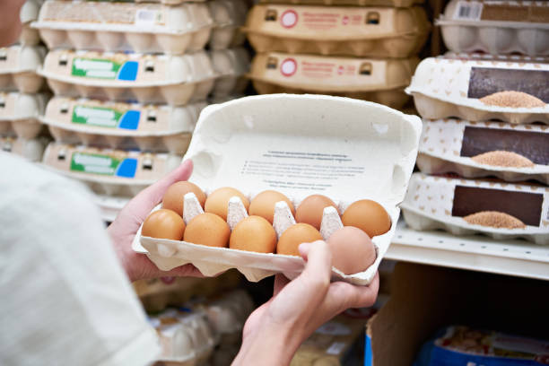 istock Hands with packages of eggs in store 1471198536