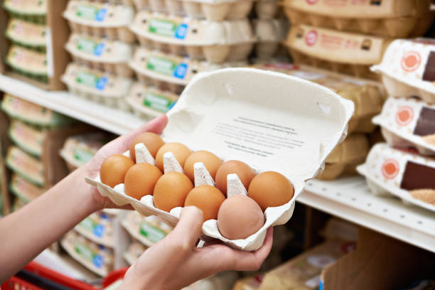 istock Hands with packages of eggs in store 1471198669