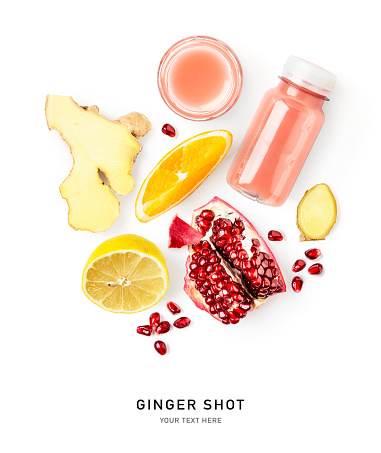 Ginger shot bottle and fresh fruits isolated on white background. Creative layout. Flat lay, top view. Design element. Healthy eating and immunity booster concept