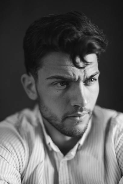 istock Brunette man in shirt in studio on black background 1471202242