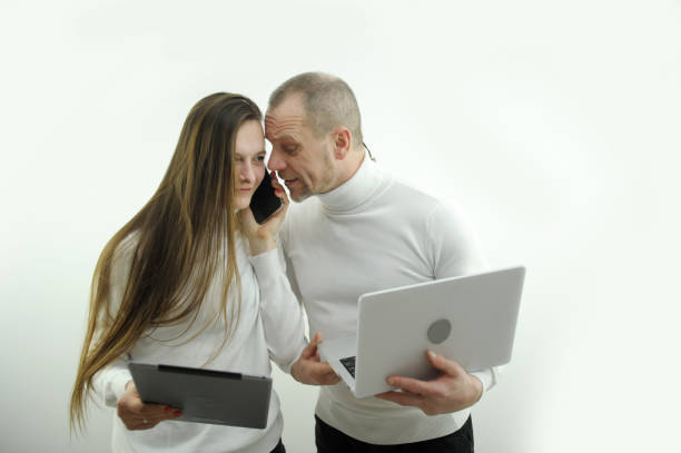 istock man and woman business work boss and subordinate in hands laptop tablet phone problem solving talking on the phone on a white background teacher and student father and daughter joint project 1471203740