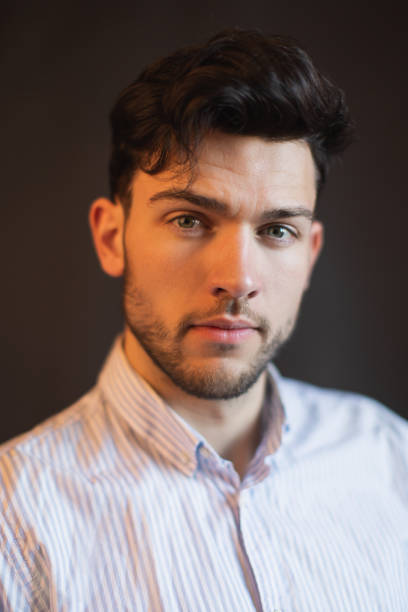 istock Brunette man in shirt in studio on black background 1471203777