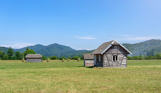 Old wooden house on the background of mountains