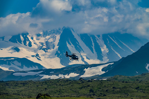 The helicopter brought tourists to the mountain plateau, volcanic magma fields. Gorgeous landscapes of Kamchatka