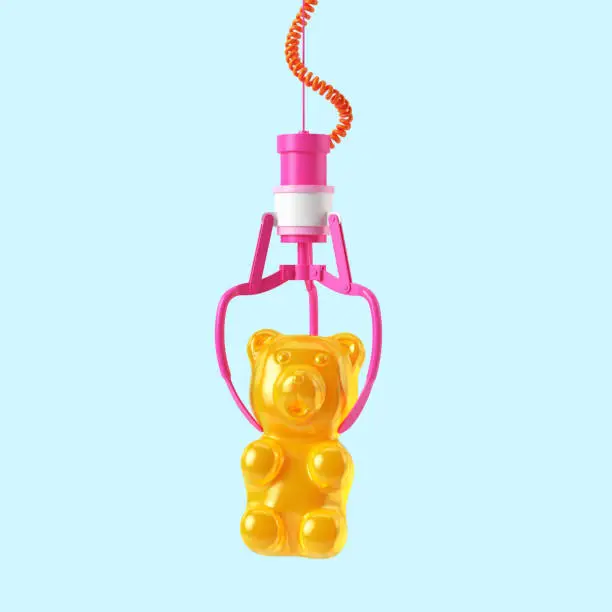 Pink robotic metal claw hold yellow Gummy Bear. Isolated on a blue pastel background. 3d rendering