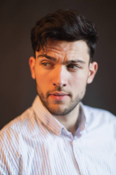 istock Brunette man in shirt in studio on black background 1471207539