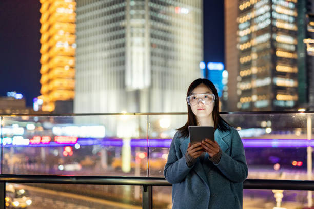 istock Young asian woman using mobile phone at night 1471212842