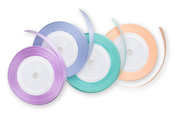 istock Rolls of satin ribbons for decorations and make shiny bows, embellished wrap package for festive, Easter, Christmas, wedding and birthday gift box. Isolated on white background 1471214236