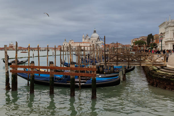 Travel destination: Venetian gondolas moored in a canal in Venice, Italy.