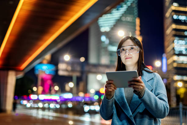 istock Young asian woman using mobile phone at night 1471215962