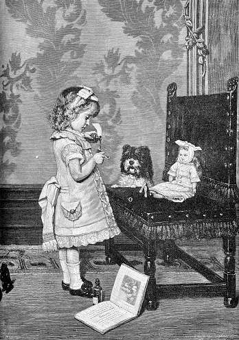 Vintage fun and humor, girl plays doctor giving a medicine spoon to her doll with toothache