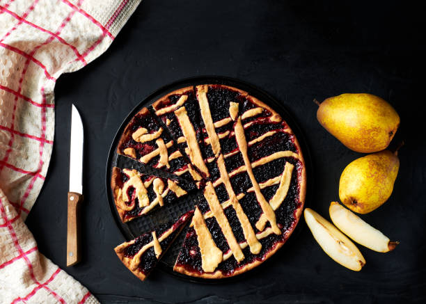 istock pie and pears are laid out on a black background next to a kitchen towel 1471218437