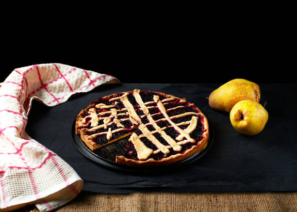 istock pie and pears are laid out on a black background next to a kitchen towel 1471218466
