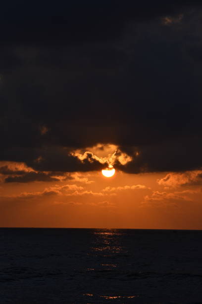 istock orange sun under the black clouds 1471222560