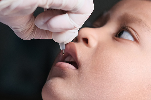 Administering oral polio virus vaccine to toddlers