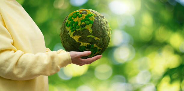istock Woman holds a green planet Earth. 1471224582