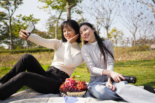 istock Asian sisters video calling on mobile phone 1471225539