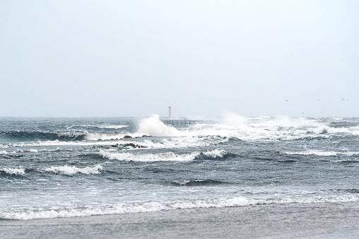 Stormy winter day at baltic sea on Mangalsala pier in Riga