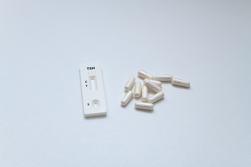 quick test with white capsules on white background, medicine concept