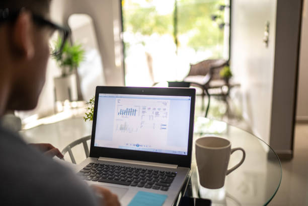 istock Man analyzing his investments in laptop at home 1471231289