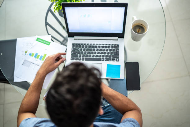istock Man analyzing his investments in laptop at home 1471231307
