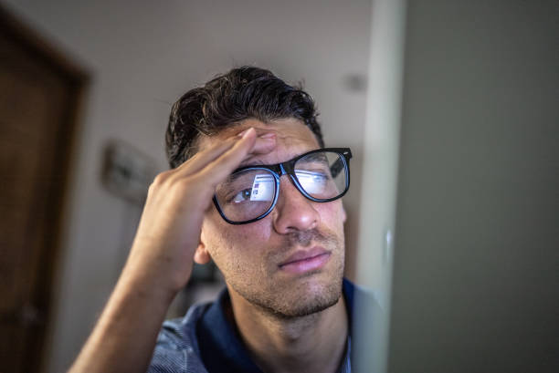 istock Worried young man working using laptop at home 1471231549