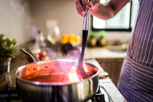 Tomato sauce being cooked in a sauce pan in a domestic kitchen