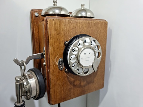 Vintage teleohone with dial and handset. Technology example hundred years ago.