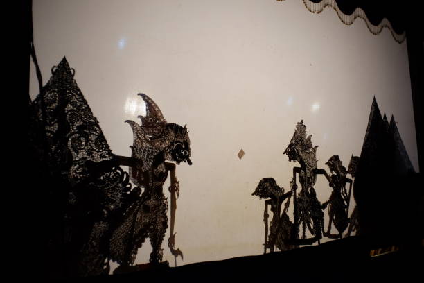 Shadow puppet figures on back light screen Shadow puppet figures on back light screen. The cultural heritage of traditional performing arts which is popular among Javanese. wayang kulit stock pictures, royalty-free photos & images