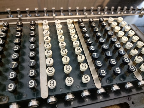 A closeup of a vintage typewriter keyboard letters