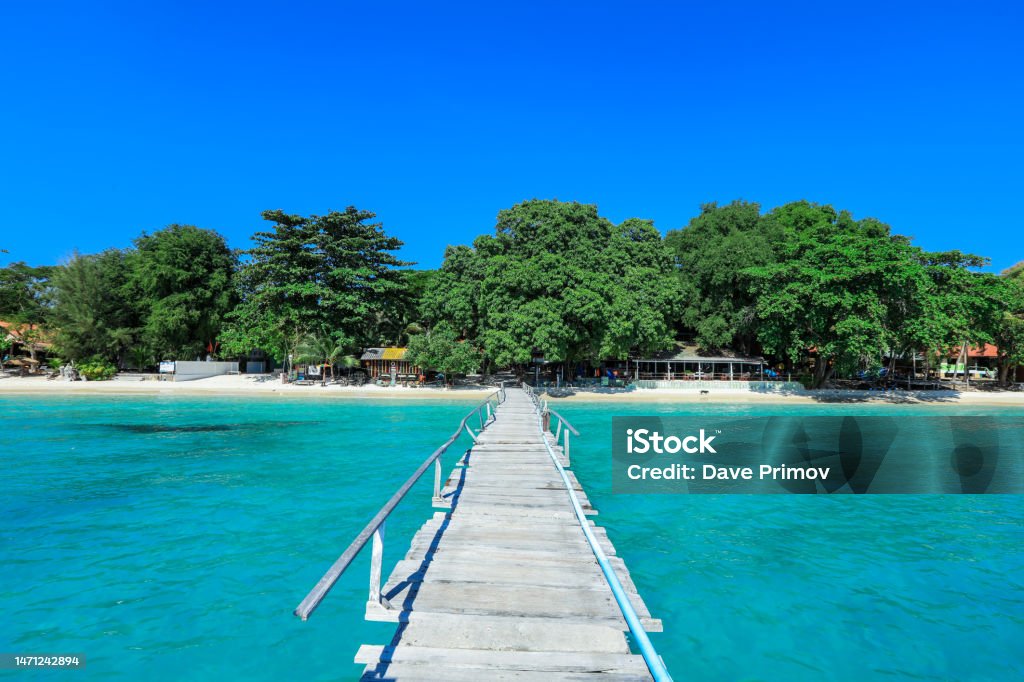 Wooden Pier to the Paradise Island on the Samet Island Wooden Pier to the Paradise Island on the Samet Island, Thailand Architectural Column Stock Photo